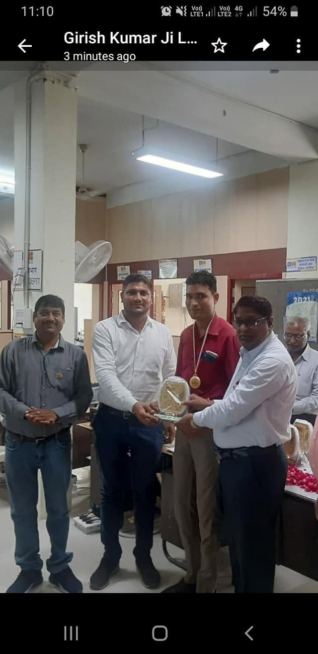 Mohan Lal Mali receiving recognition award with a memento
